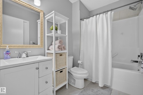 White bath over shower with chrome fixtures - 11018 122 Street Nw, Edmonton, AB - Indoor Photo Showing Bathroom