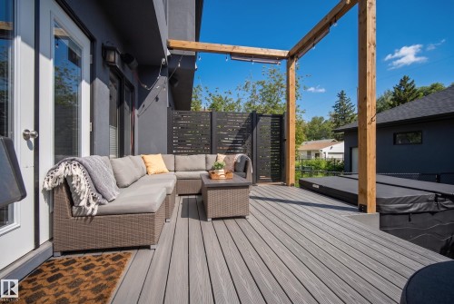 Expansive composite deck featuring a wooden pergola, outdoor privacy screens, and an integrated spa - 11018 122 Street Nw, Edmonton, AB - Outdoor With Deck Patio Veranda With Exterior