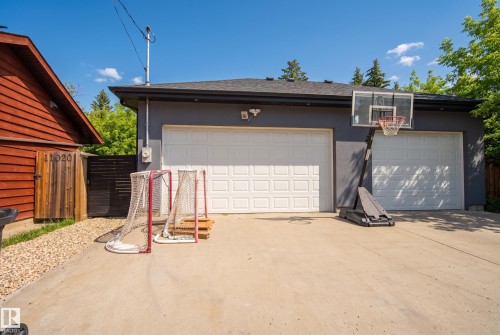 Two-car garage with white panel doors and a concrete driveway - 11018 122 Street Nw, Edmonton, AB - Outdoor With Exterior
