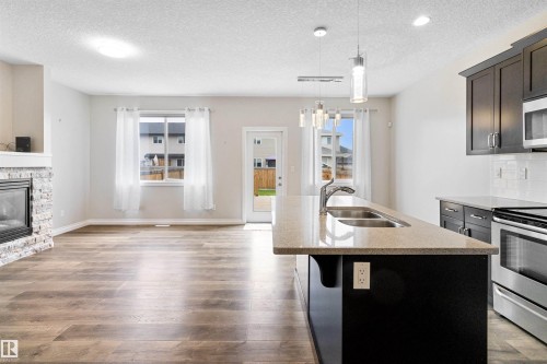 37 Roseberry Lane, Fort Saskatchewan, AB - Indoor Photo Showing Kitchen With Fireplace With Double Sink With Upgraded Kitchen
