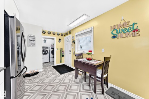 Eat-in kitchen featuring patterned flooring and a window with blinds - 10524 128 Avenue Nw, Edmonton, AB - Indoor Photo Showing Other Room