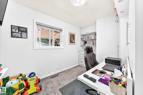 Built-in desk area with integrated shelving, recessed lighting, and a window with natural light - 10524 128 Avenue Nw, Edmonton, AB - Indoor Photo Showing Office