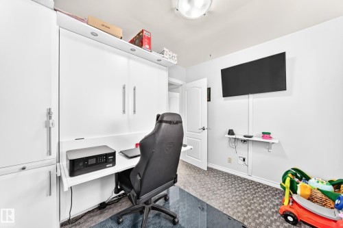 Built-in cabinetry with integrated desk, overhead lighting, and wall-mounted shelving - 10524 128 Avenue Nw, Edmonton, AB - Indoor Photo Showing Office