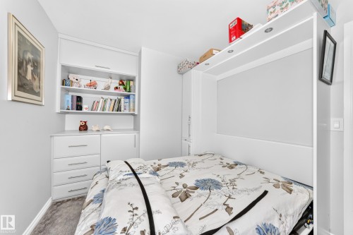 Built-in wall unit with integrated shelving, storage, and a convertible bed - 10524 128 Avenue Nw, Edmonton, AB - Indoor Photo Showing Bedroom