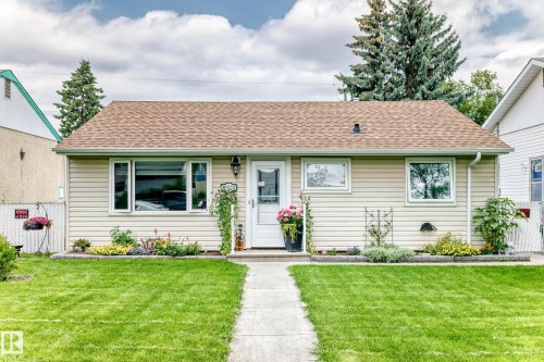 Siding exterior with a gabled roof, prominent front entry door, and perimeter landscaping - 10524 128 Avenue Nw, Edmonton, AB - Outdoor