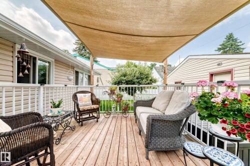 Wood-finish decking with a fabric shade structure - 10524 128 Avenue Nw, Edmonton, AB - Outdoor With Deck Patio Veranda With Exterior
