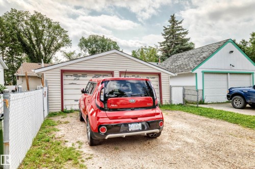 Two detached garages with overhead doors and vinyl siding - 10524 128 Avenue Nw, Edmonton, AB - Outdoor