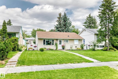 Single-story residence featuring light-colored siding and a brown shingle roof - 10524 128 Avenue Nw, Edmonton, AB - Outdoor With Facade
