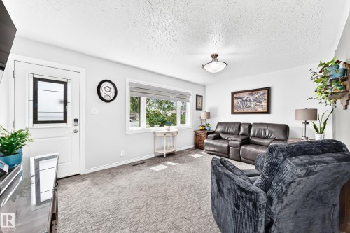 White painted walls, carpeted flooring, a ceiling-mounted light fixture, and a window with blinds - 10524 128 Avenue Nw, Edmonton, AB - Indoor Photo Showing Other Room