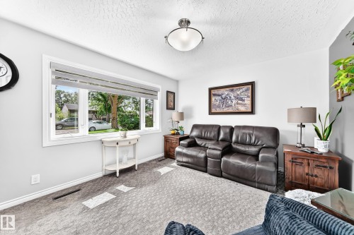 Recessed lighting, large window, neutral wall paint, ceiling-mounted light fixture - 10524 128 Avenue Nw, Edmonton, AB - Indoor Photo Showing Living Room