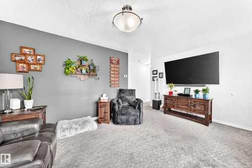 Textured ceiling, wall-mounted light fixture, and carpeted flooring - 10524 128 Avenue Nw, Edmonton, AB - Indoor Photo Showing Other Room