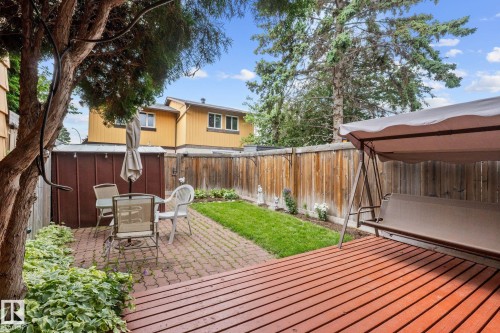 Expansive backyard featuring a large wood deck, brick paver patio, and fenced perimeter - 152 Woodstock Nw, Edmonton, AB - Outdoor With Deck Patio Veranda