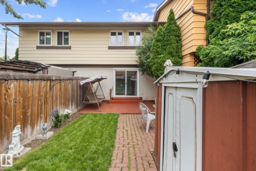 Rear exterior with light-colored siding and multiple windows - 152 Woodstock Nw, Edmonton, AB - Outdoor With Exterior