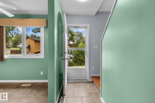 White-framed window, tile flooring, and light-toned wall finishes - 152 Woodstock Nw, Edmonton, AB - Indoor Photo Showing Other Room