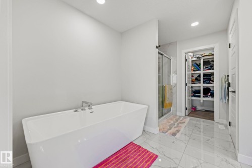 Freestanding soaking tub with chrome fixtures - 16128 31 Avenue Sw, Edmonton, AB - Indoor Photo Showing Bathroom