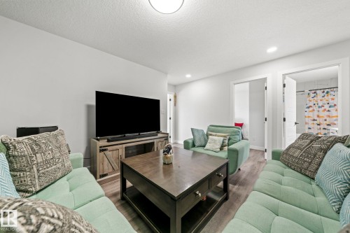 Recessed lighting, wood-finish flooring, and light-toned walls - 16128 31 Avenue Sw, Edmonton, AB - Indoor Photo Showing Living Room