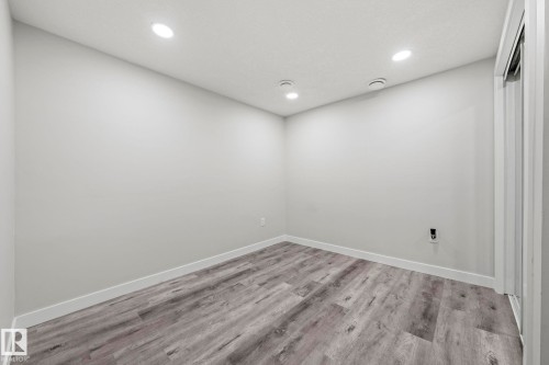 Recessed ceiling lighting, wood-finish flooring, and white trim - 16128 31 Avenue Sw, Edmonton, AB - Indoor Photo Showing Other Room