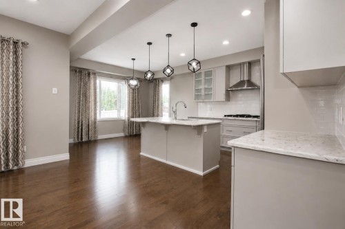 Hardwood flooring throughout, recessed lighting, and a kitchen island with pendant lighting - 7274 Morgan Road Nw, Edmonton, AB - Indoor Photo Showing Kitchen With Upgraded Kitchen