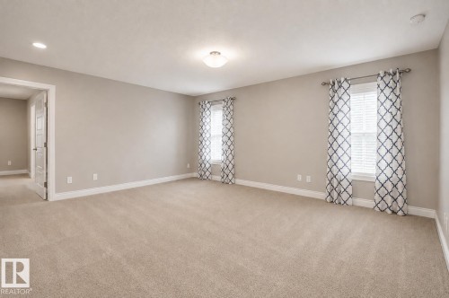 Neutral-toned carpeting, recessed lighting, and a semi-flush mount ceiling fixture - 7274 Morgan Road Nw, Edmonton, AB - Indoor Photo Showing Other Room