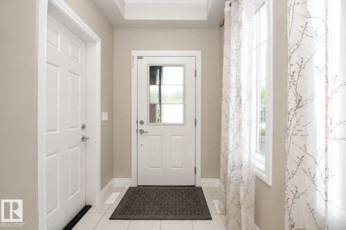 Foyer with tiled flooring, white trim, and a recessed ceiling feature - 7274 Morgan Road Nw, Edmonton, AB - Indoor Photo Showing Other Room