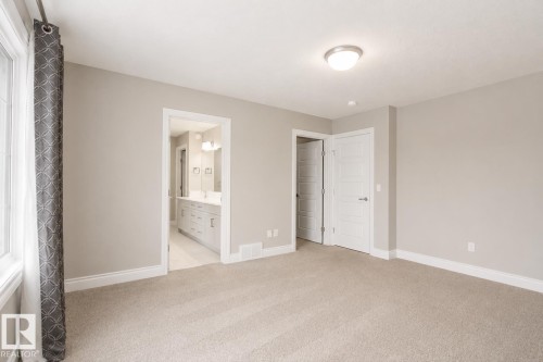 Recessed lighting, light-colored wall paint, carpet flooring, a window, and a built-in light fixture - 7274 Morgan Road Nw, Edmonton, AB - Indoor Photo Showing Other Room