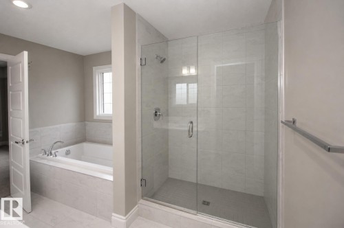 Soaking tub with tile surround, glass-enclosed shower with tile walls, and recessed ceiling lighting - 7274 Morgan Road Nw, Edmonton, AB - Indoor Photo Showing Bathroom