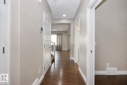 Hallway with wood-finish flooring, recessed lighting, and neutral wall tones - 7274 Morgan Road Nw, Edmonton, AB - Indoor Photo Showing Other Room