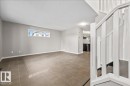 Open-concept living area with neutral gray walls and large format tile flooring - 1086 Grantham Drive Nw, Edmonton, AB  - Indoor Photo Showing Other Room 