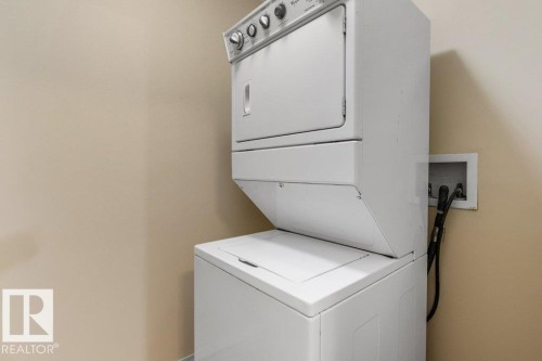 Stackable washer and dryer unit - #307 1188 Hyndman Rd Nw, Edmonton, AB - Indoor Photo Showing Laundry Room