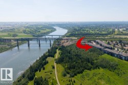 Riverside setting with multiple bridges, adjacent to a wooded area and multi-story residential buildings - 