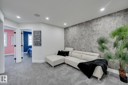 Carpeted flooring, recessed ceiling lighting, textured accent wall, white trim, and white doors with dark hardware - 51 Clichy Close, St. Albert, AB - Indoor