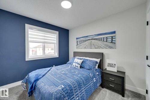Window with blinds, wall-to-wall carpeting, white painted walls, accent wall, and flush-mount ceiling light - 51 Clichy Close, St. Albert, AB - Indoor Photo Showing Bedroom