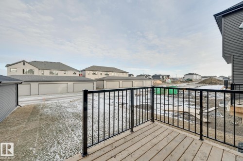 Wood-finish deck with black metal railing - 51 Clichy Close, St. Albert, AB - Outdoor With Exterior