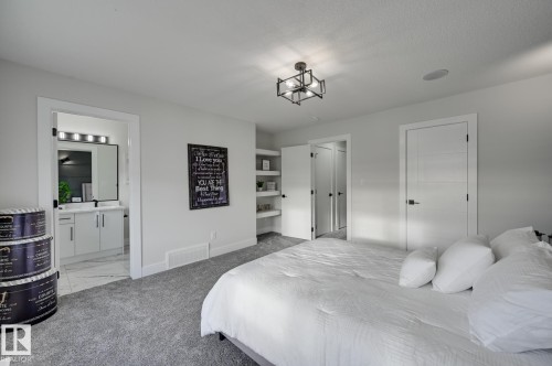 Recessed lighting, built-in shelving, and a modern ceiling fixture - 51 Clichy Close, St. Albert, AB - Indoor Photo Showing Bedroom