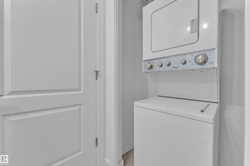 Stackable laundry unit - #217 667 Watt Bv Sw, Edmonton, AB - Indoor Photo Showing Laundry Room