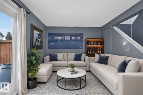 Spacious living area featuring neutral wall tones and a white ceiling - 1344 Lakewood Road West Nw, Edmonton, AB - Indoor Photo Showing Living Room