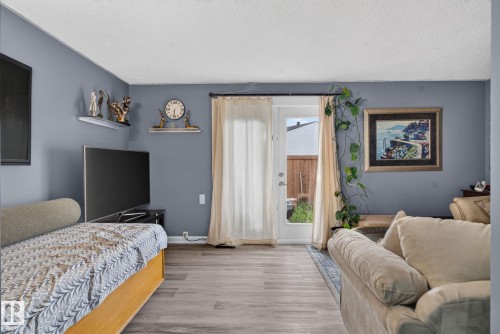 Living area featuring wood-finish flooring and a neutral color palette - 1344 Lakewood Road West Nw, Edmonton, AB - Indoor Photo Showing Bedroom