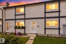 Stucco exterior featuring dark trim accents, a concrete walkway, and an established lawn - 1344 Lakewood Road West Nw, Edmonton, AB  - Outdoor 