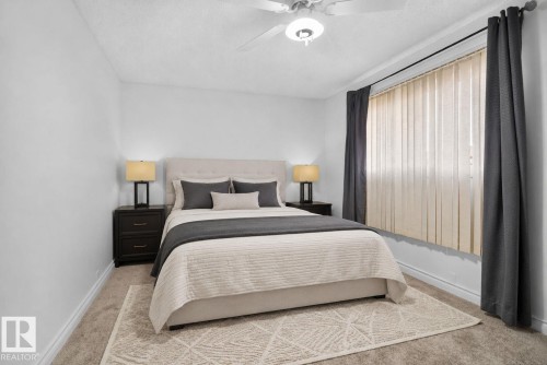 Carpeted room featuring a ceiling fan with integrated lighting, a window with vertical blinds, and dark drapery panels - 1344 Lakewood Road West Nw, Edmonton, AB - Indoor Photo Showing Bedroom