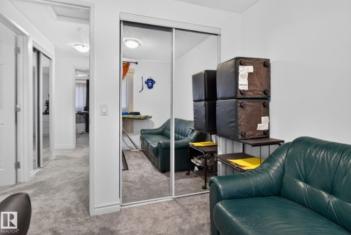 Mirrored closet doors providing light reflection, neutral carpeting, and white painted walls - 1344 Lakewood Road West Nw, Edmonton, AB - Indoor
