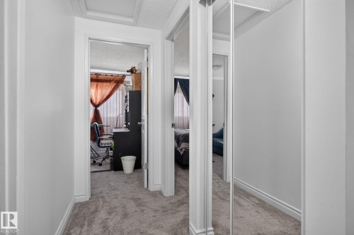 Hallway featuring textured carpeting and white painted walls - 1344 Lakewood Road West Nw, Edmonton, AB - Indoor Photo Showing Other Room