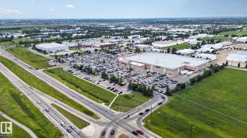 Large commercial complex featuring extensive paved parking, multiple loading docks, and direct access to a multi-lane highway - 1344 Lakewood Road West Nw, Edmonton, AB - Outdoor With View