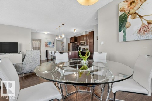 Open concept living area with wood-finish flooring - #423 320 Ambleside Li Sw, Edmonton, AB - Indoor