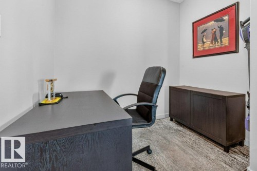Wood-finish flooring with light wall paint - #423 320 Ambleside Li Sw, Edmonton, AB - Indoor Photo Showing Office