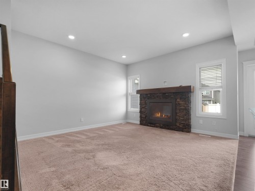 428 Simpkins Link, Leduc, AB - Indoor Photo Showing Living Room With Fireplace