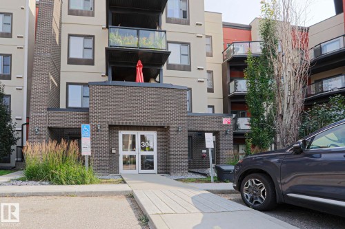 Multi-story building exterior with brick and stucco siding - #209 304 Ambleside Link Li Sw Sw, Edmonton, AB - Outdoor With Balcony With Facade