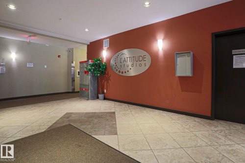 Tiled flooring with contrasting sections, recessed ceiling lighting, and wall-mounted sconces - #209 304 Ambleside Link Li Sw Sw, Edmonton, AB - Indoor Photo Showing Other Room