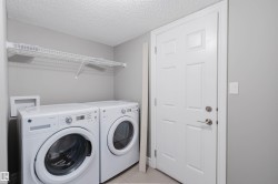 Laundry area with a wire shelf, light gray walls, and a paneled door - 
