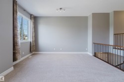 Spacious room with light-toned carpeting and neutral wall tones - 