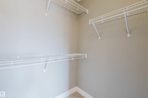 Built-in wire shelving and hanging rods - 15839 10 Avenue Sw, Edmonton, AB - Indoor With Storage